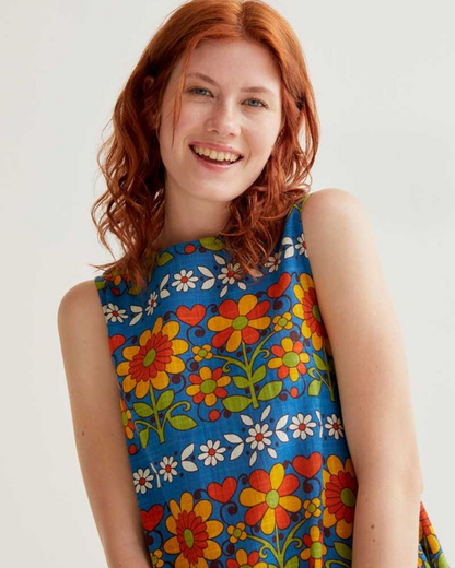 Woman wearing a colorful floral dress against a white background
