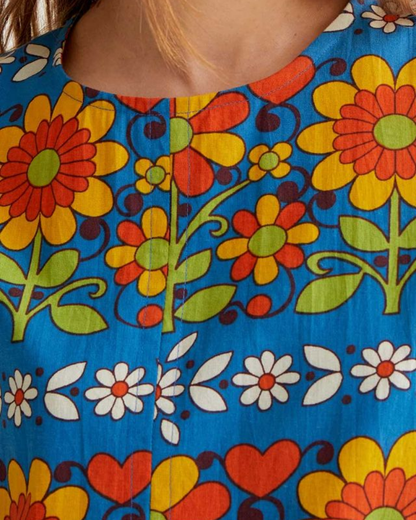 Close-up of a colorful floral pattern with bright flowers on a blue background.