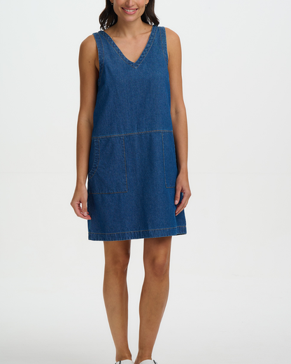 Woman wearing a blue denim dress on a white background