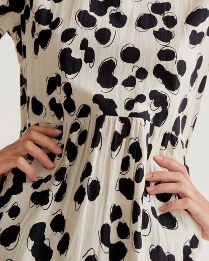 Close-up of a dress with black abstract patterns on a white background