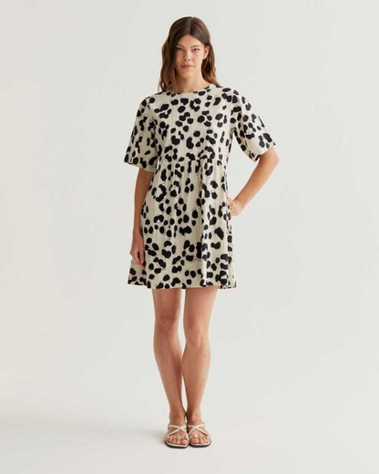 Woman wearing a leopard print dress on a white background