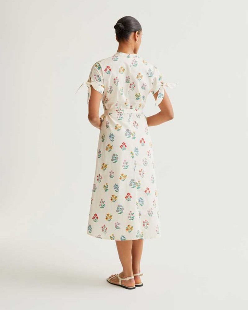 Woman wearing a floral dress on a white background