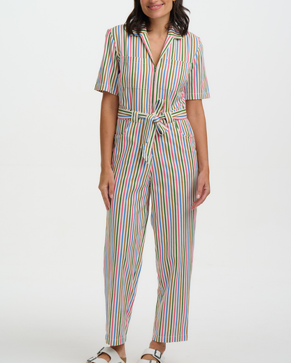 Woman wearing a colorful striped jumpsuit on a white background