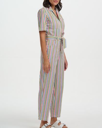 Woman wearing a colorful striped jumpsuit on a white background