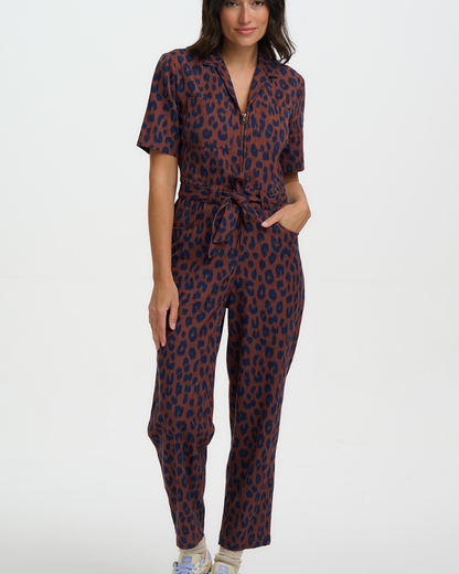 Woman wearing a leopard print jumpsuit on a white background