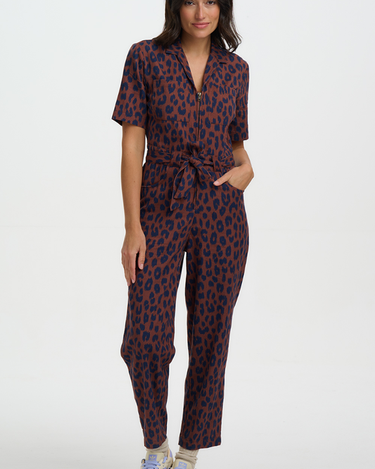 Woman wearing a leopard print jumpsuit on a white background