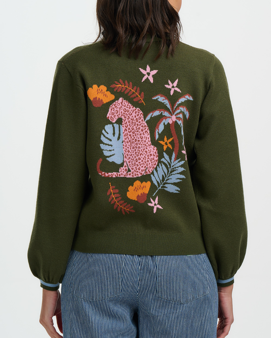 Green sweater with colorful leopard design on a white background