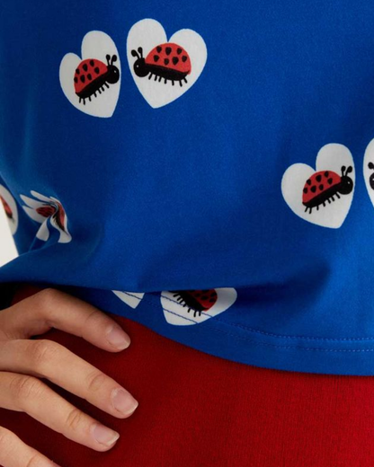 Blue shirt with ladybug pattern worn by a person