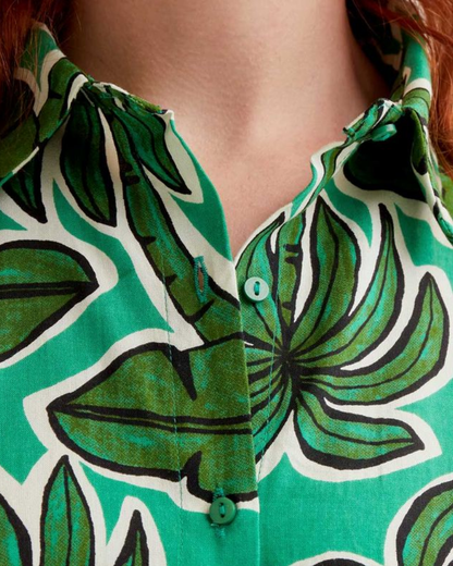 Close-up of a person wearing a green leaf-patterned shirt.