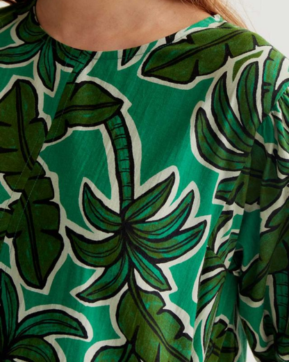 Close-up of a green patterned garment with leaf designs.